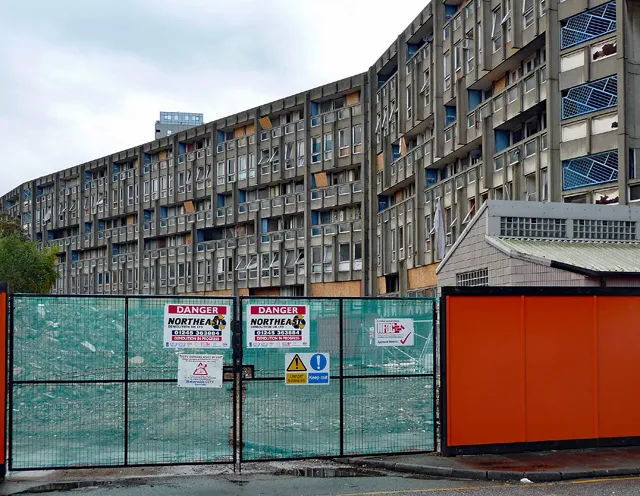 Robin Hood Gardens behind site hoarding, Woolmore Street