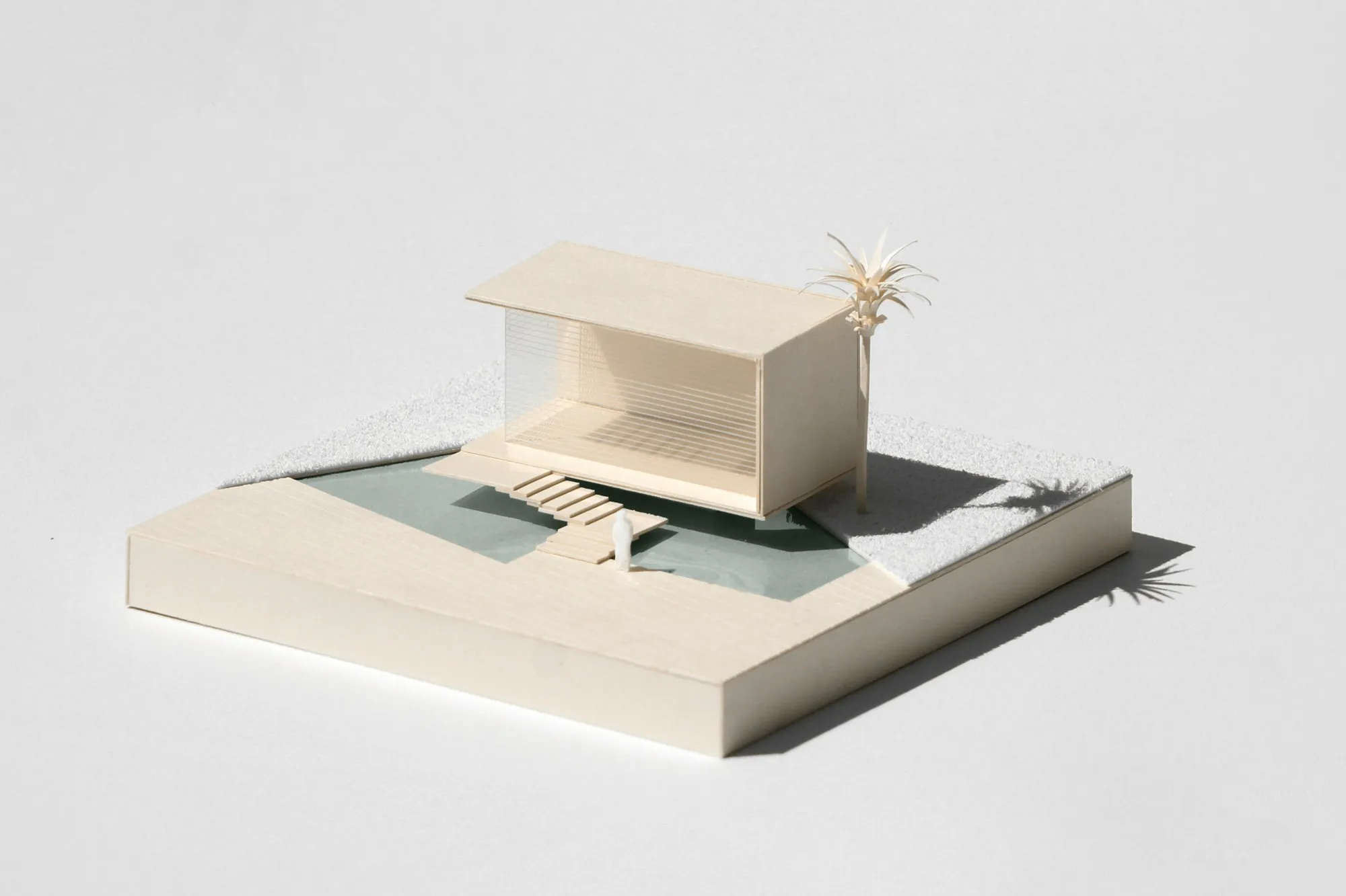 Cream architectural model of a pavilion on a landscaped base in soft daylight, clean white background