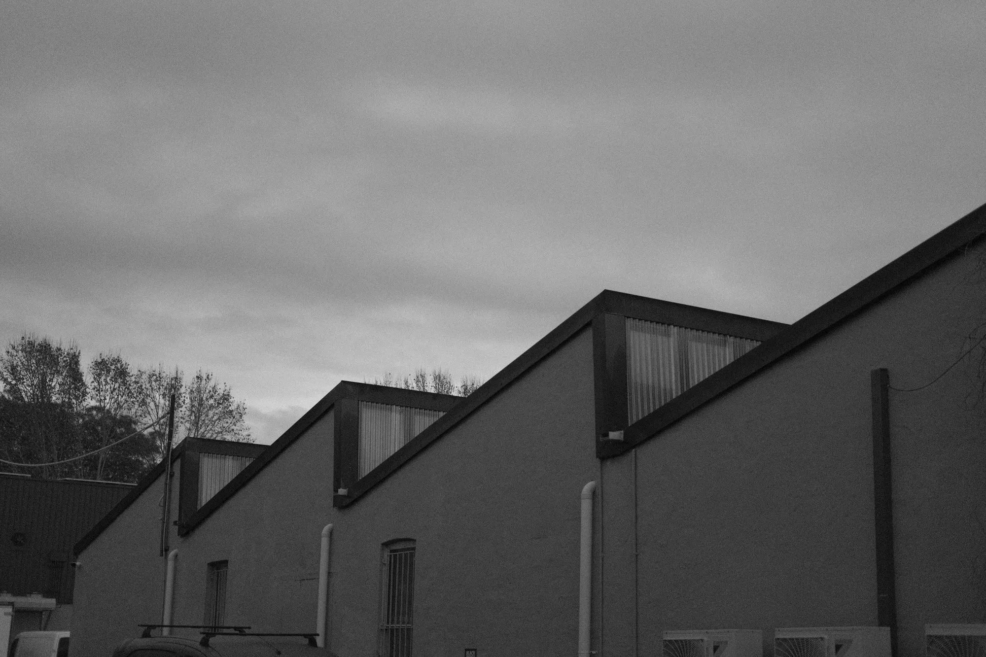 Sawtooth industrial roof with glazed rooflight panels, black and white