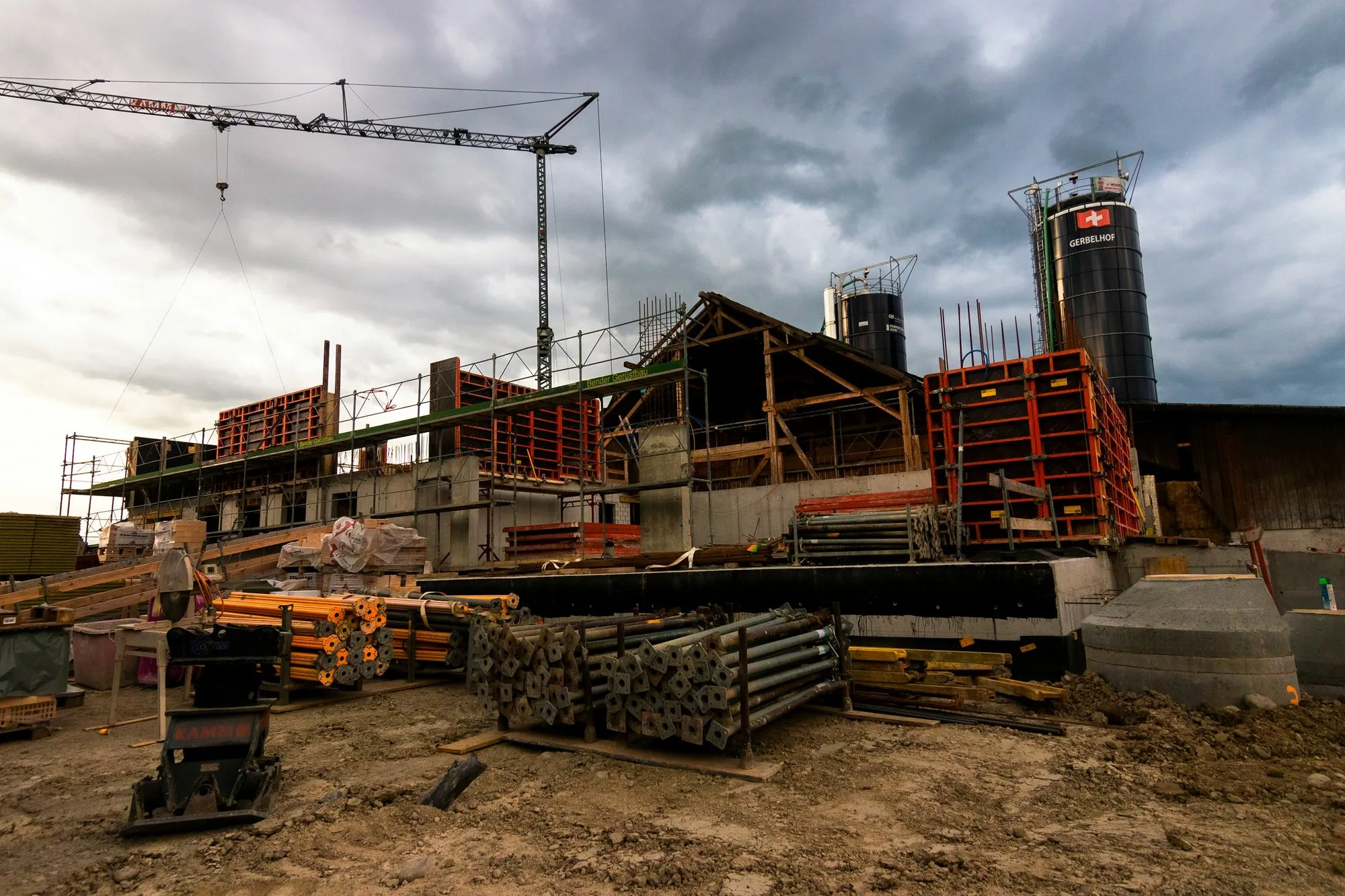 Concrete frame, formwork and a tower crane on a building site