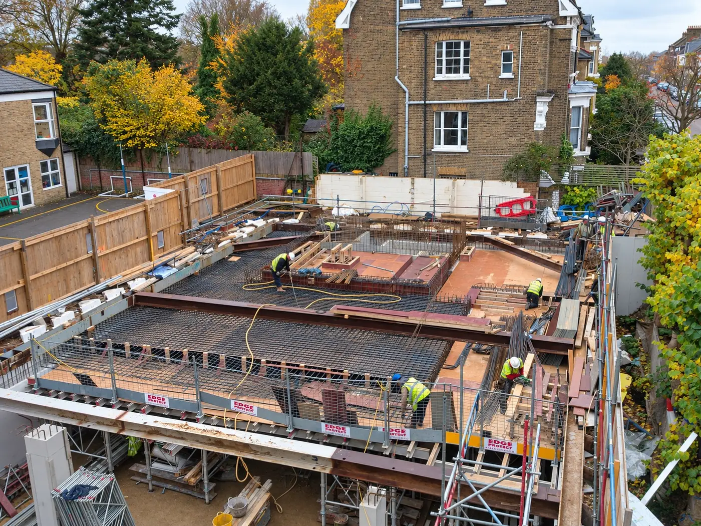 Operatives fixing reinforcement on a first-floor deck on a London new-build site