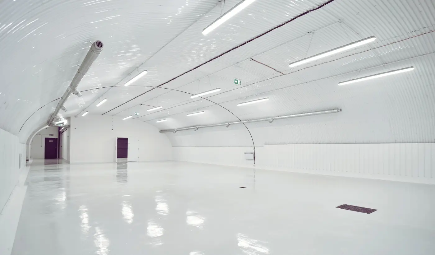 Fitted railway-arch warehouse with LED batten lighting, delivered by Craftex for Drake's in London