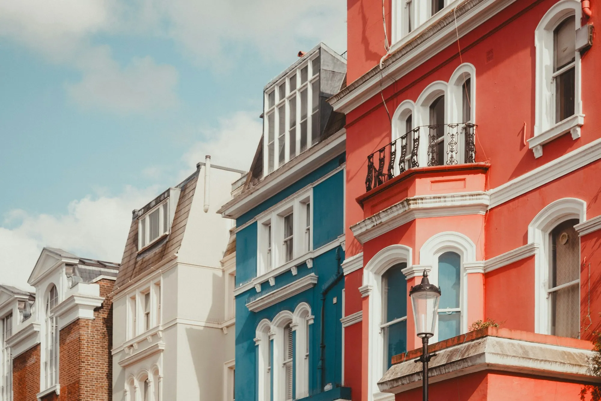 Colourful Victorian terraced townhouses with bay windows and balconies in London