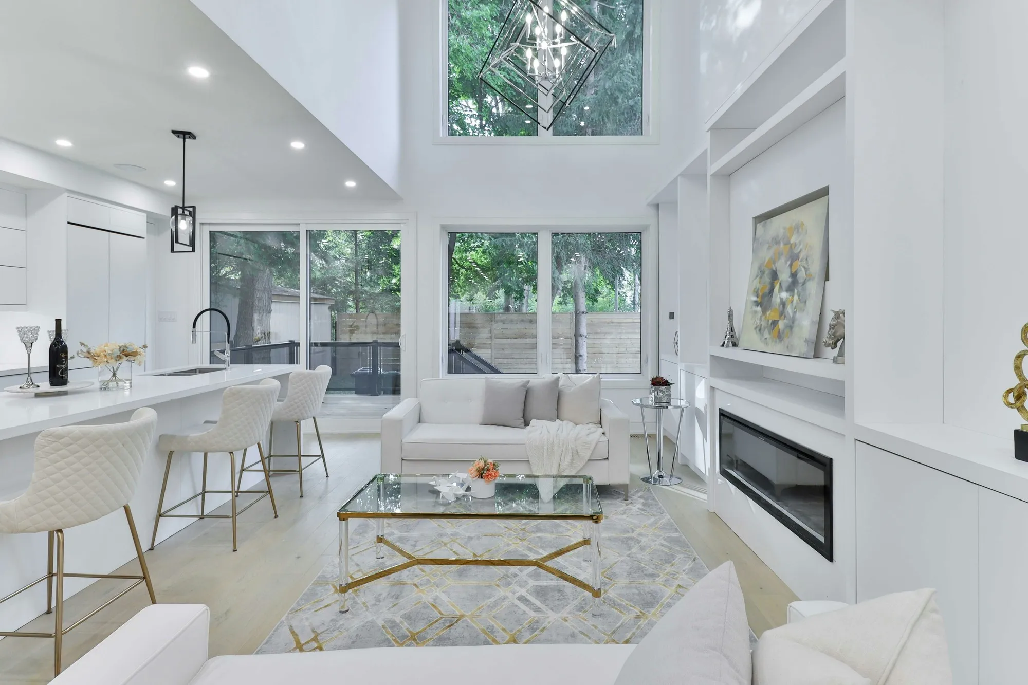 Bright double-height living room with built-in joinery, fireplace and sofas