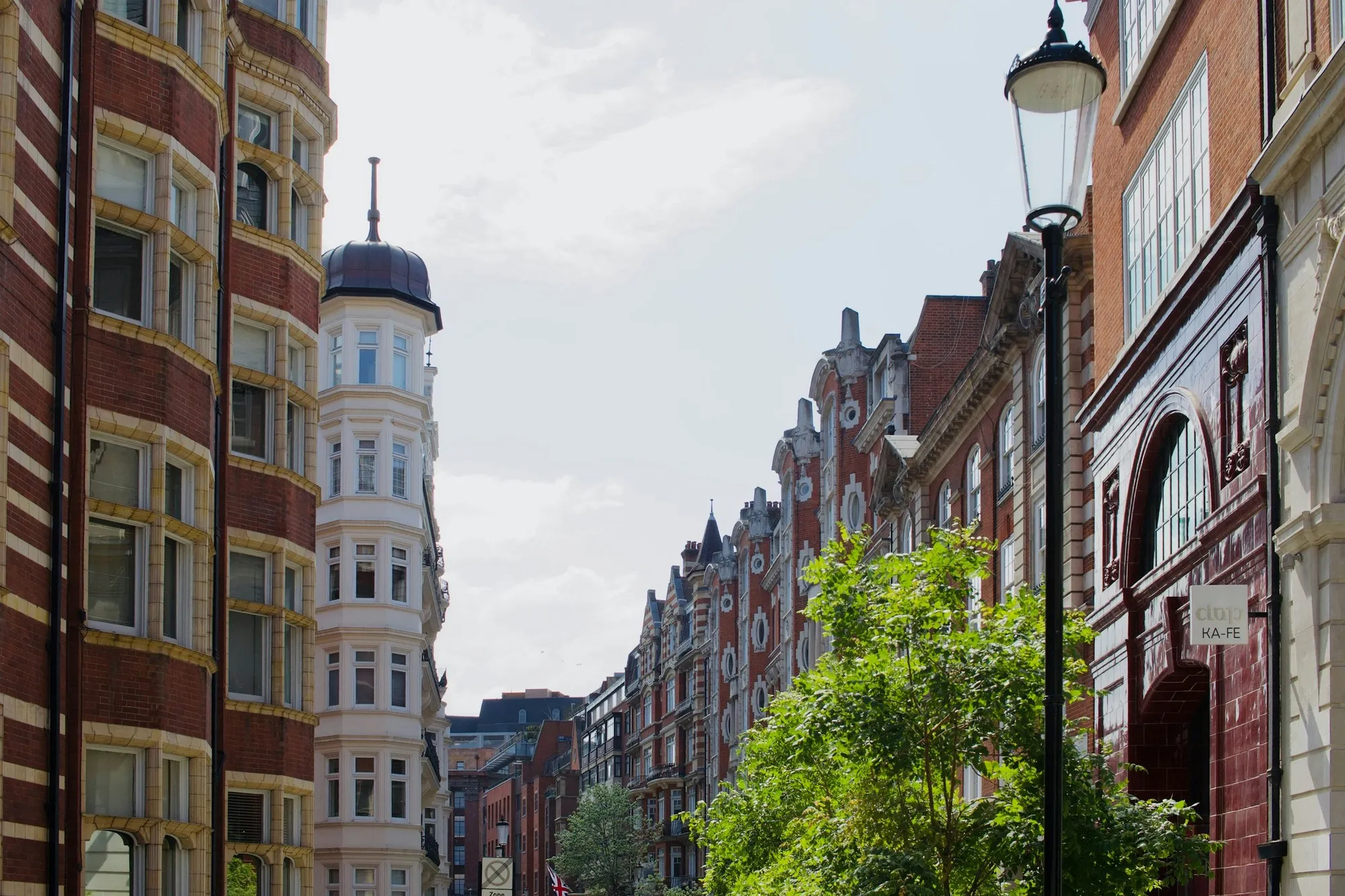 Victorian red-brick mansion blocks on a tree-lined London street