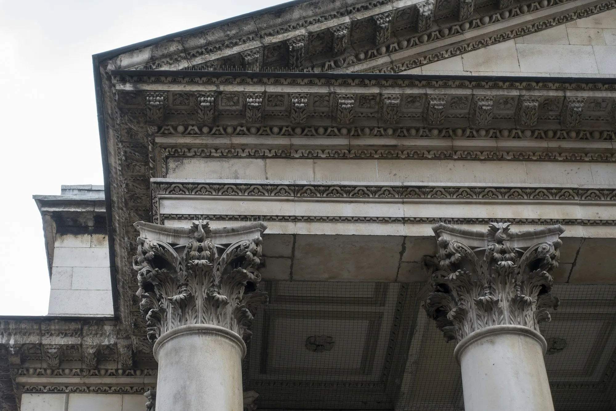 Corinthian columns and pediment of a Grade II listed stone portico on Regent Street, London