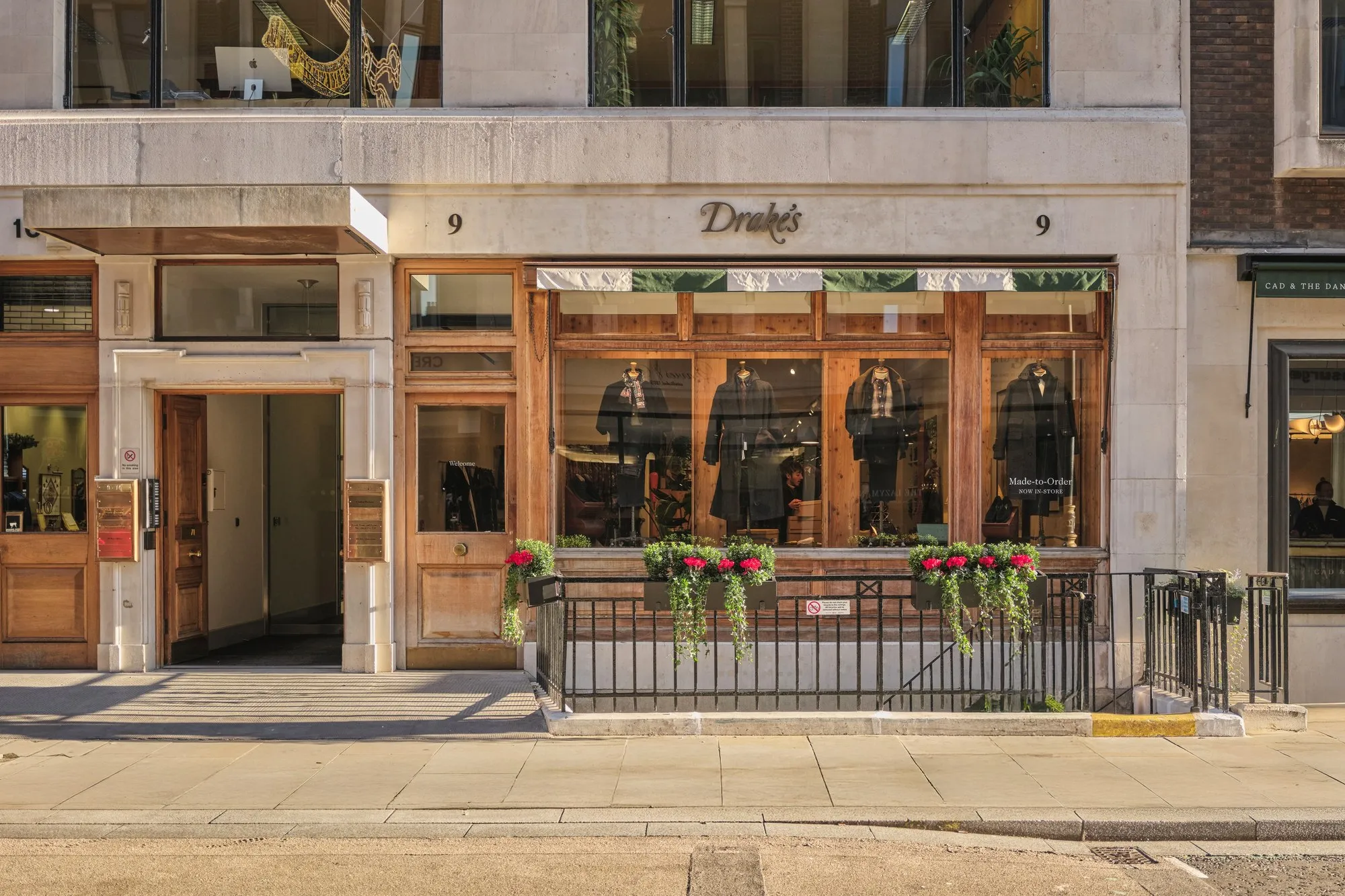 Drake's new timber shopfront at 9 Savile Row with planted window boxes