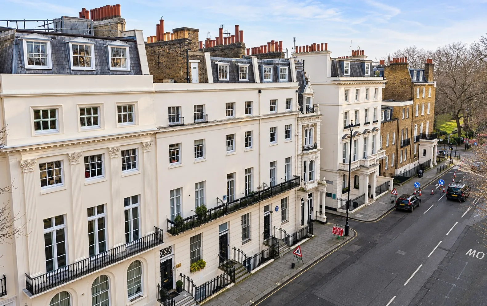 White stucco terrace on Hobart Place in Belgravia, seen from first-floor height across the street