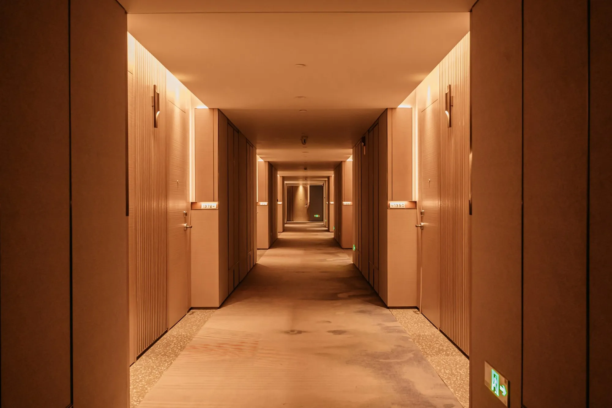 Premium hotel lobby with a reception desk and lounge seating in warm light