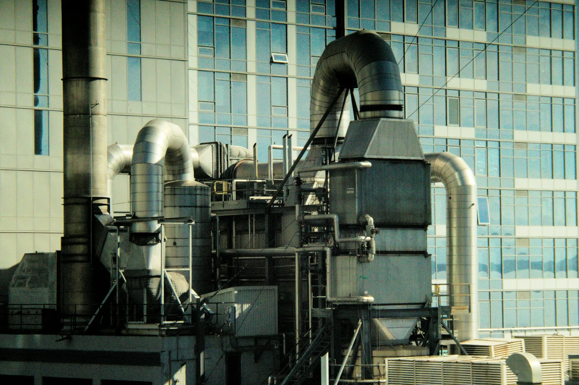 Air handling plant and ductwork beside a glazed building