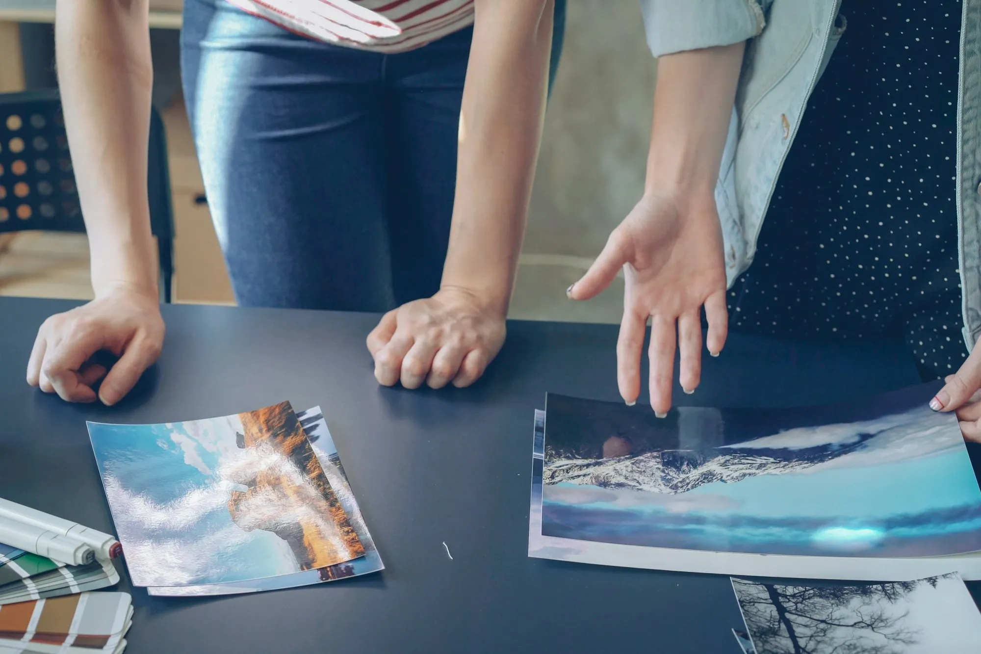 Designers comparing finish samples and images on a table