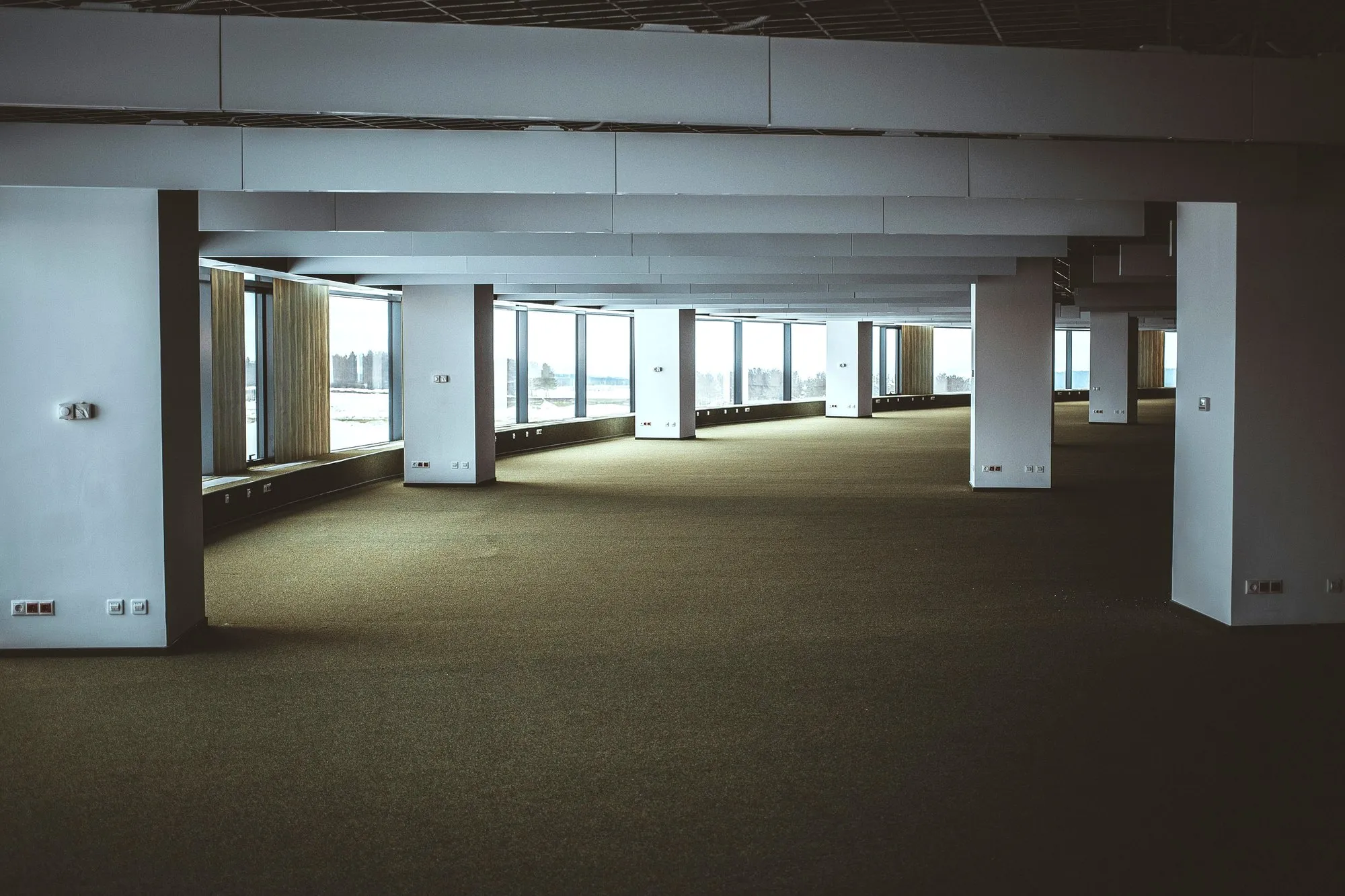 Empty Cat A office floor with columns and full-height windows