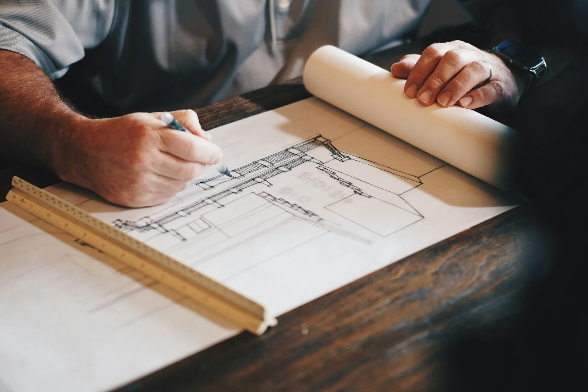 Architect drawing a building section by hand on tracing paper