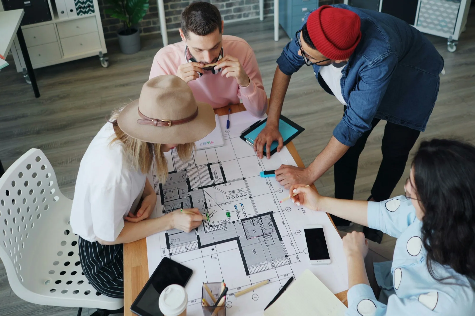 Design team around a table working through a floor plan