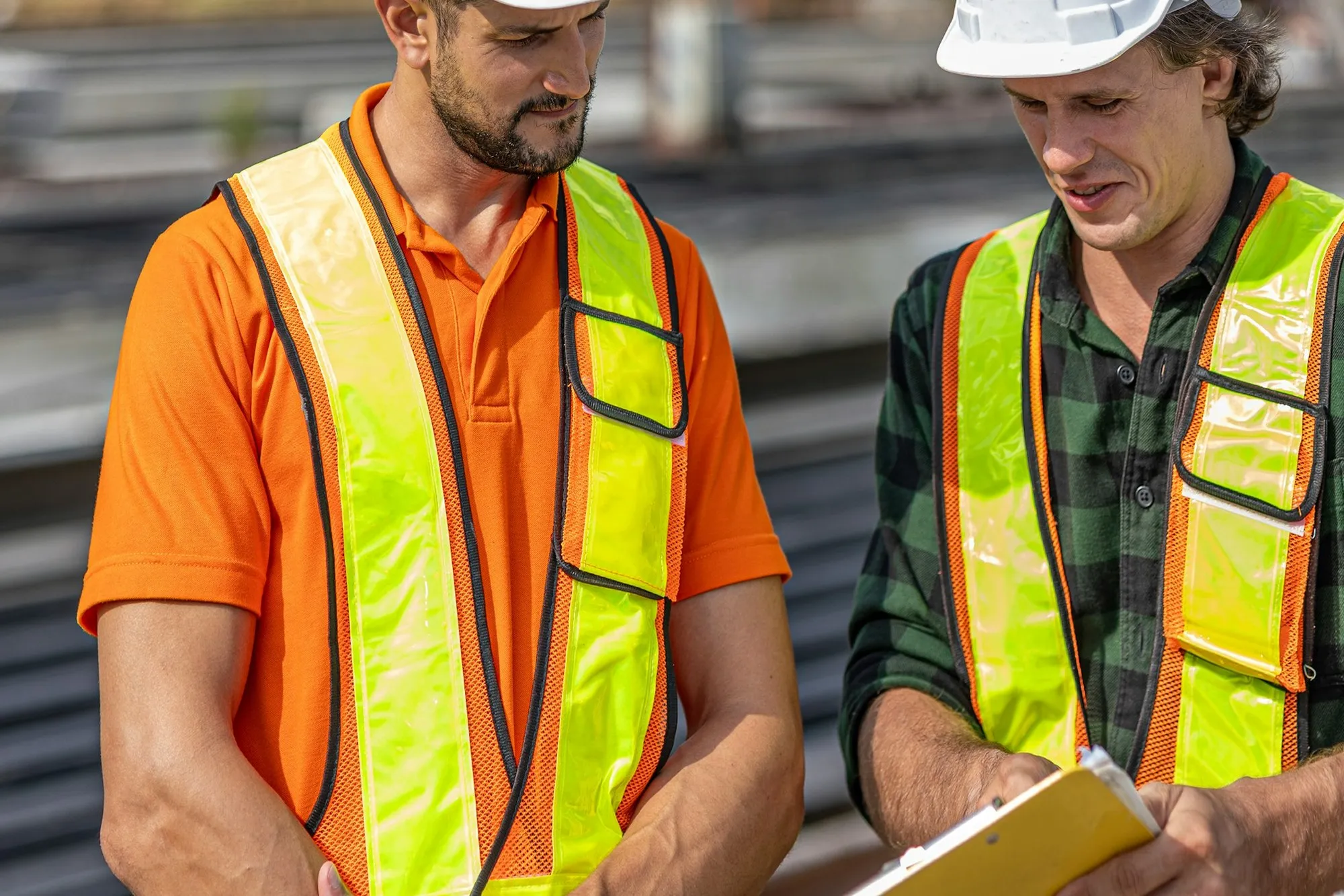 Site supervisor and engineer checking progress against the programme