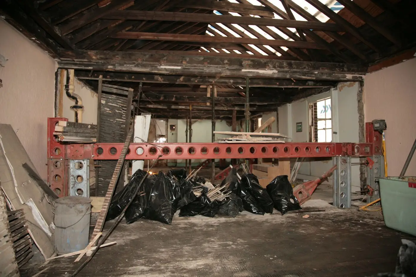 Strip-out with temporary steel props during the Gloucester Arms pub refurbishment, London