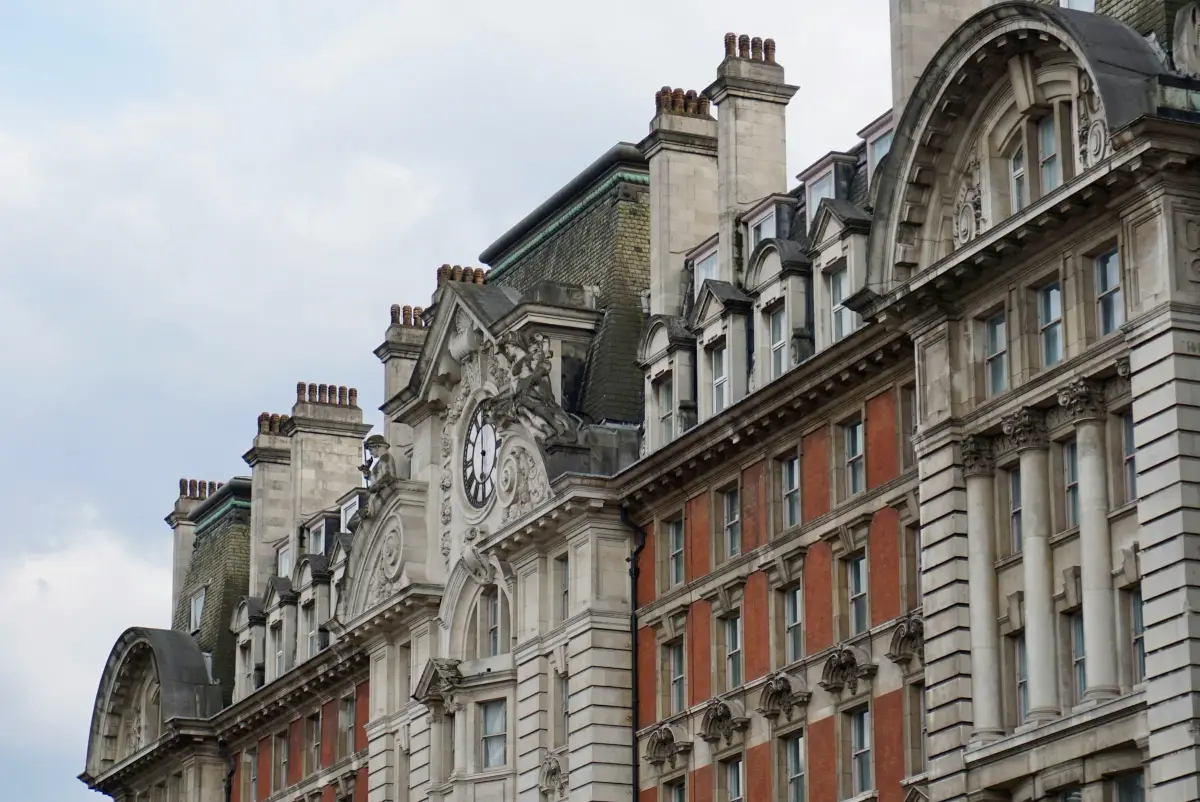 Ornate period commercial building with stone and brick facades under a cloudy sky