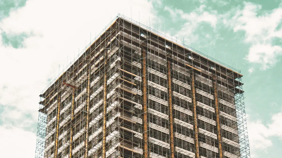 Residential tower block in London wrapped in full scaffold from the roof edge to the lower floors