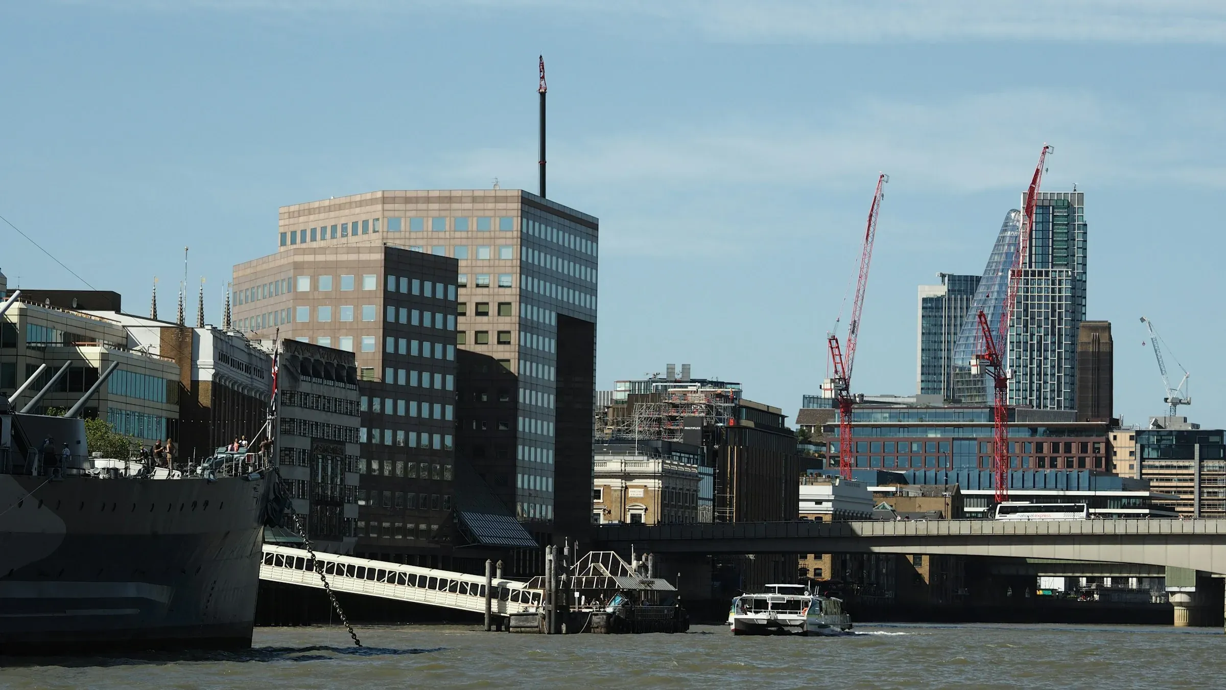 Office buildings and tower cranes on the River Thames in London