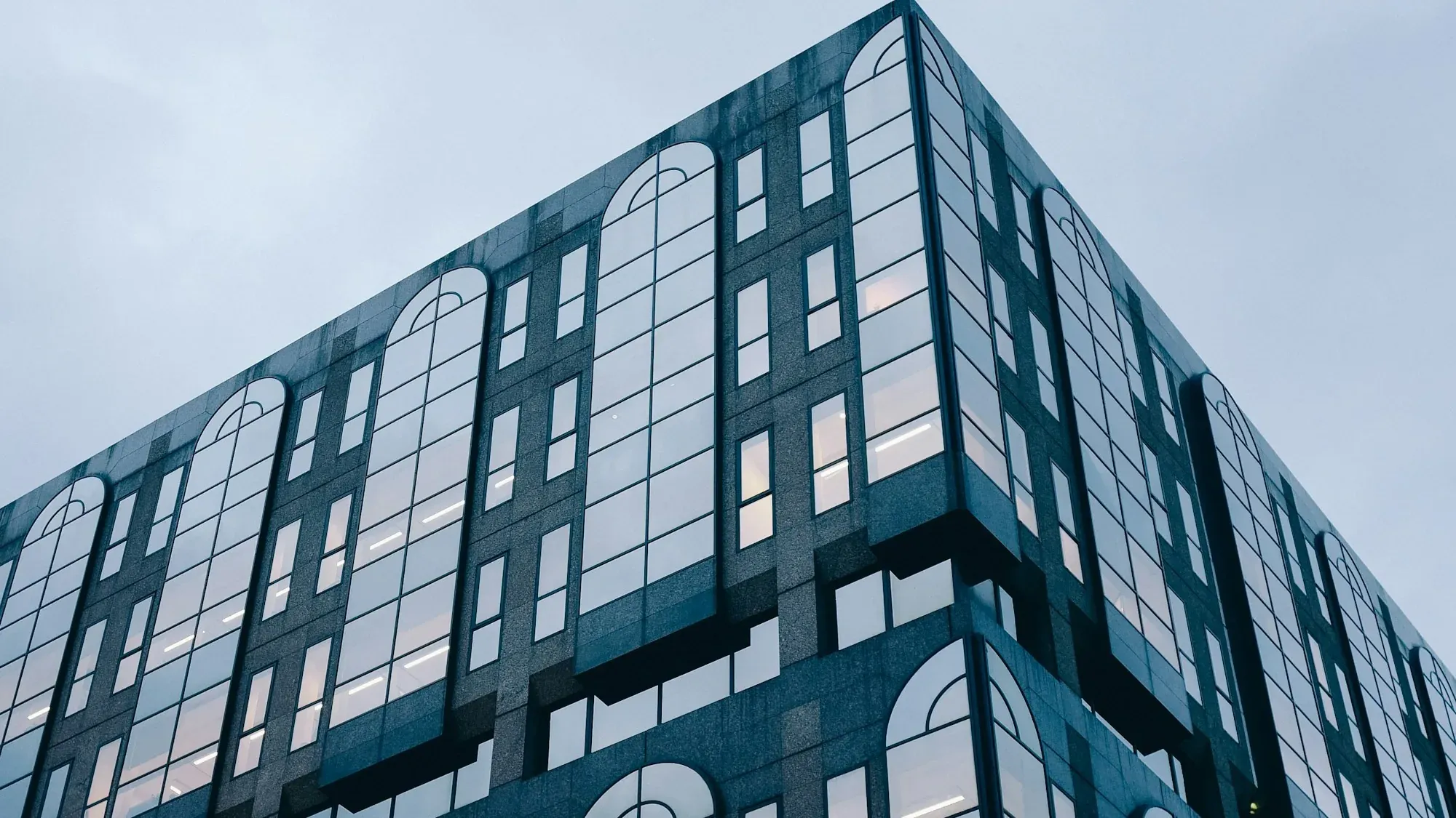 A glazed London office block: whether it can become homes without a full application depends on the direction over its address