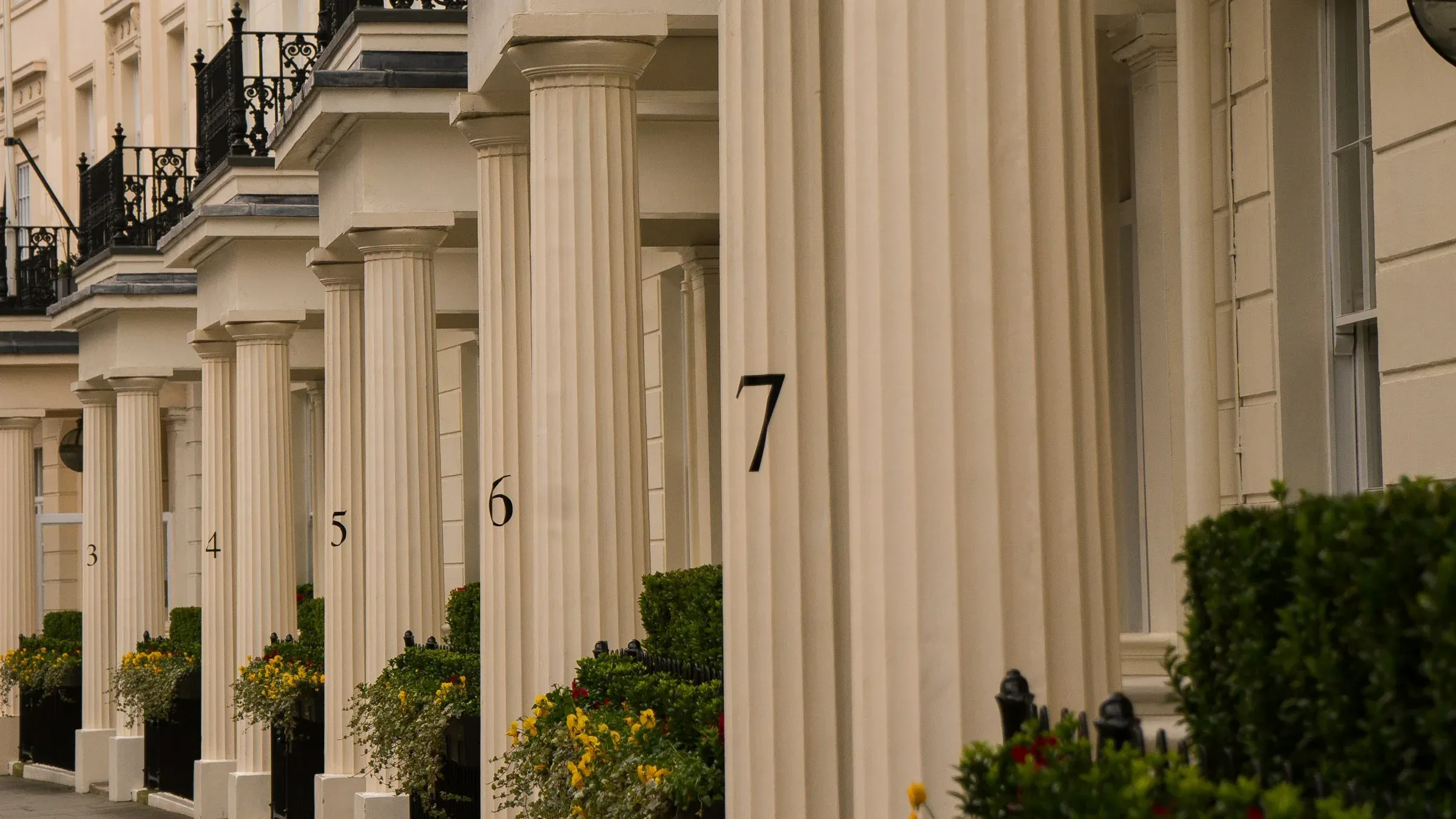 A stucco terrace with sash windows and iron balconies, the kind of frontage a conservation-area direction protects