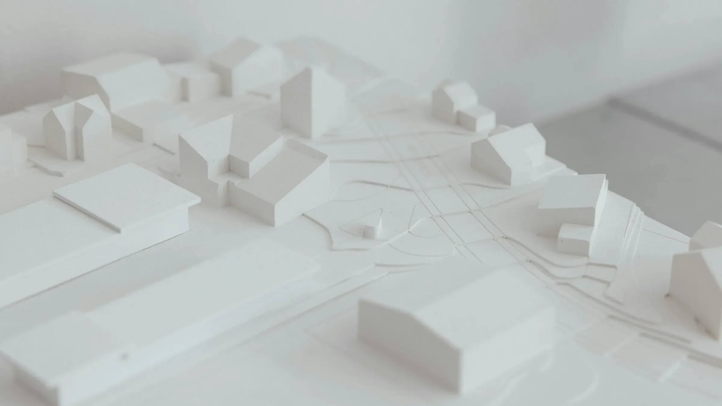 White architectural model of houses and apartment blocks along a street