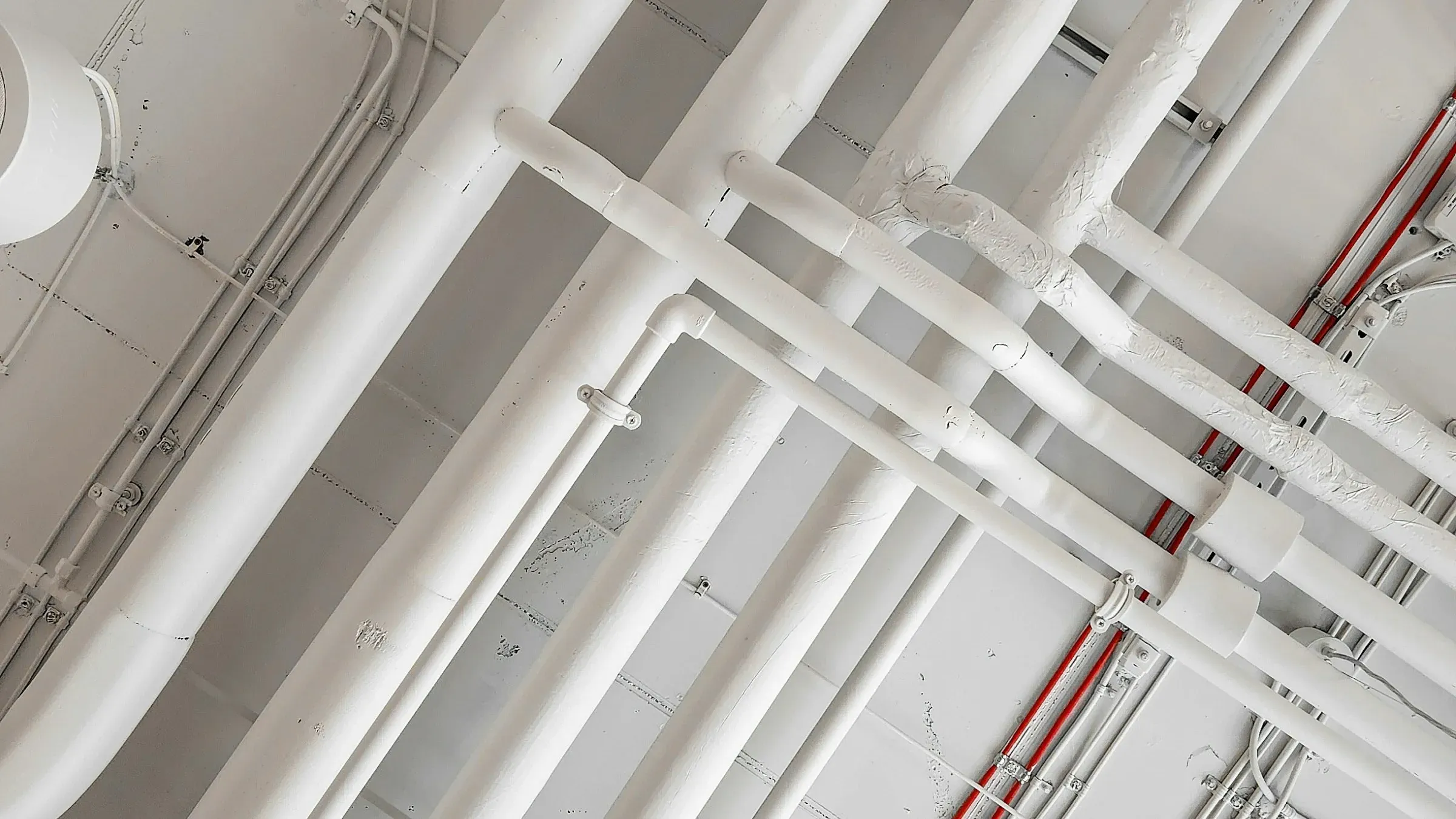 Ductwork, pipework and cable containment exposed in an office ceiling void once the old ceiling is removed