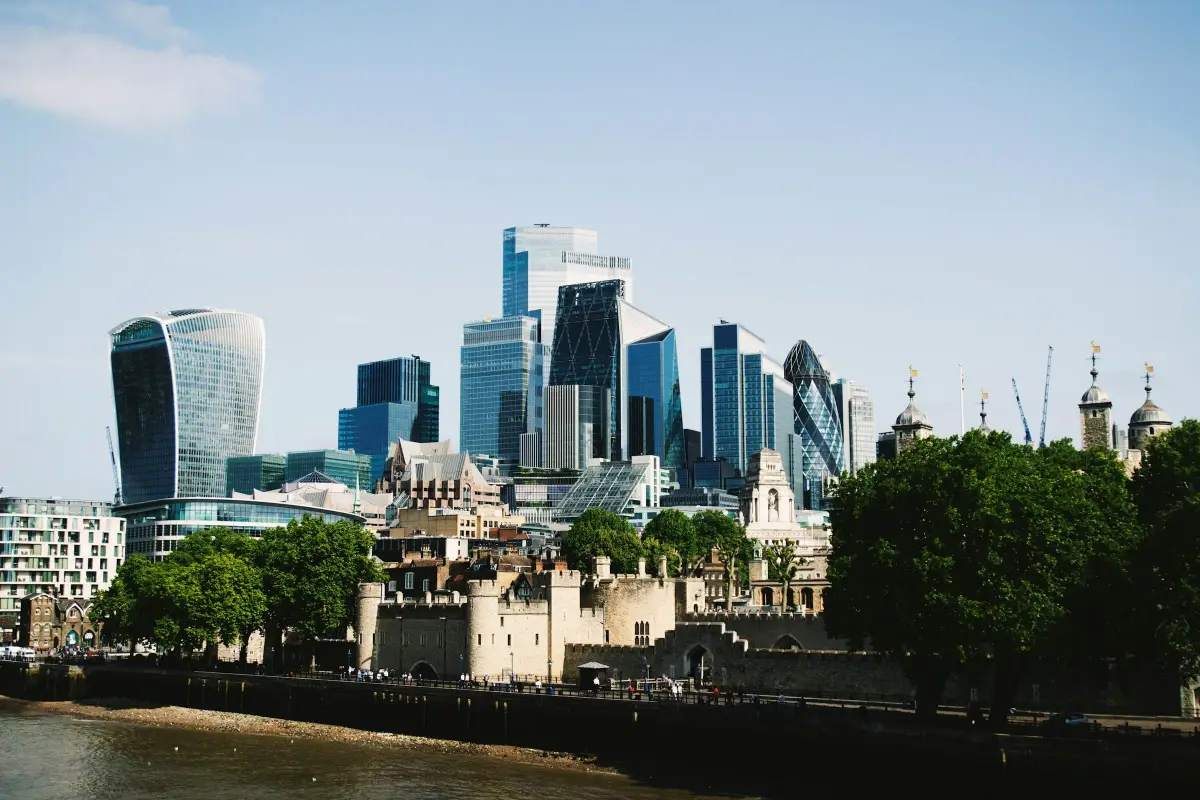 City of London office towers rising behind the Tower of London and the Thames on a clear day
